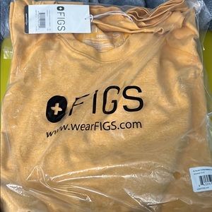 FIGS. STILL IN ORIGINAL PACKAGING FIGS SIZE XL UNDER SHIRT.